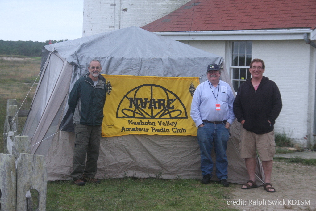 Jim K1PTF, Roland NR1G, and Bruce K1BG in front of NVARC banner
